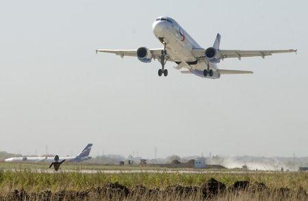 An Airbus A320-211 airplane lands near a new runway which is under construction at the airport of Russia's far eastern city of Vladivostok, October 6, 2010. PHOTO BY REUTERS/Yuri Maltsev