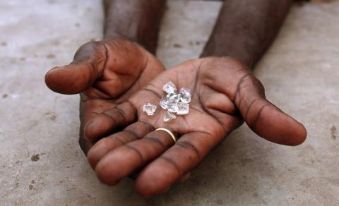 A diamond dealer from Zimbabwe displays diamonds for sale in Manica, near the border with Zimbabwe. PHOTO BY REUTERS/Goran Tomasevic
