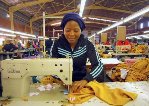 A woman works at a clothing factory at the industrial town of Newcastle, 260 km (162 miles) southeast of Johannesburg. PHOTO BY REUTERS/Jon Herskovitz