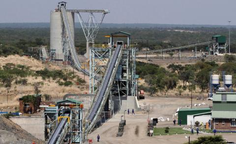 Employees walk under a concentrator at Ngezi platinum processing plant near Harare, November 28, 2013. PHOTO BY REUTERS/Philimon Bulawayo