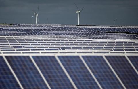 A solar power plant is seen past wind turbines in Canino, central Italy, April 27, 2016. PHOTO BY REUTERS/Max Rossi