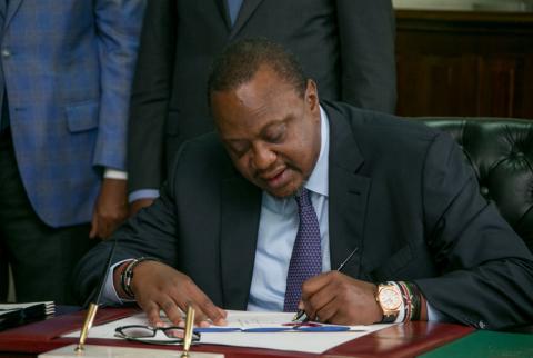 Kenya's President Uhuru Kenyatta signs into law the Finance Bill 2019 at State House in Nairobi, Kenya, November 7, 2019. PHOTO BY REUTERS/Presidential Press Service