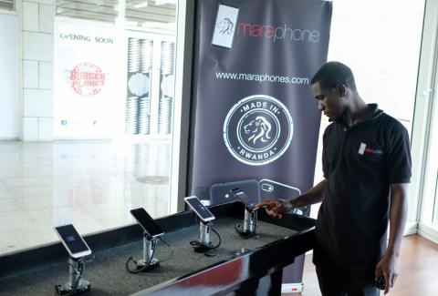 A worker operates a Mara X smartphone during the launch by Rwanda's Mara Group in Kigali, Rwanda, October 7, 2019. PHOTO BY REUTERS/Jean Bizimana