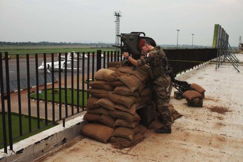 A French soldier conducts reconnaissance on the roof of the Mpoko airport in Bangui
