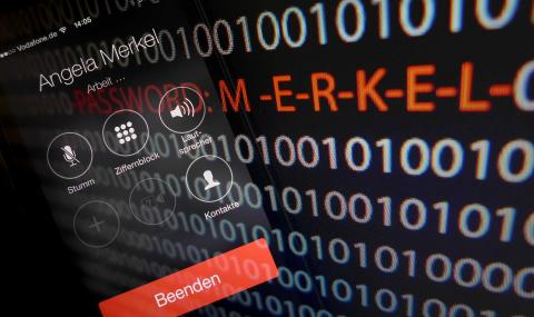 A mobile phone simulating a call to German Chancellor Angela Merkel and computer with a series of numbers