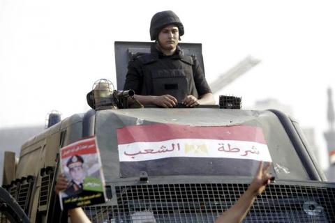 A policeman looks out from his vehicle at Tahrir square in Cairo