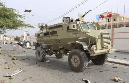 Soldiers from the African Union Mission in Somalia (AMISOM) drive their armoured personnel carrier (APC) past the scene of a suicide car explosion in front of the SYL hotel in the capital Mogadishu, January 22, 2015. PHOTO BY REUTERS/Feisal Omar