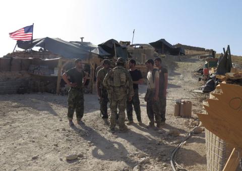 U.S. and Afghan National Army (ANA) soldiers chat with each other at a post in Deh Bala district, Nangarhar province, Afghanistan, July 7, 2018. PHOTO BY REUTERS/James Mackenzie