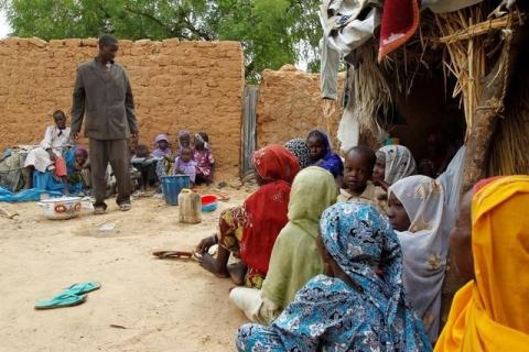 Aba Ali, a Nigerian refugee who fled from his village in northeastern Nigeria into Niger following Boko Haram attacks, stands next to his relatives at the home of Adamu Moumouni, his Nigerien host who took them in, in Diffa in southeastern Niger June 21, 2016. Picture taken June 21, 2016. PHOTO BY REUTERS/Luc Gnago