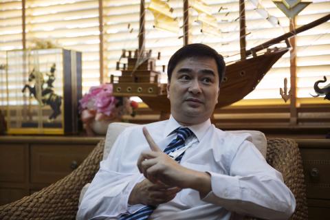 Thailand's opposition leader and former Prime Minister Abhisit Vejjajiva gestures during an interview with foreign media at his Democrat Party headquarters in Bangkok
