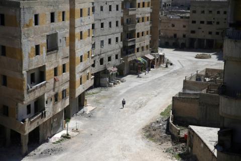 Abu Malek, one of the survivors of a chemical attack in the Ghouta region of Damascus that took place in 2013, uses his crutches to walk along a street in the Ghouta town of Ain Tarma, Syria, April 7. PHOTO BY REUTERS/Bassam Khabieh