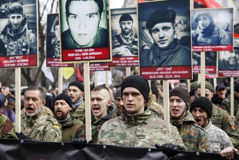 Activists of the Right Sector political party carry portraits of their comrades killed in fighting with pro-Russian separatists during an anti-government march in Kiev, February 25, 2015. PHOTO BY REUTERS/Valentyn Ogirenko