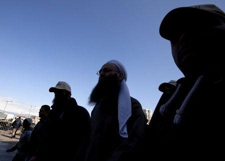 Sunni Muslim Salafist leader Ahmed al-Assir is escorted by his bodyguards after his speech to supporters during a demonstration in solidarity with Syria's anti-government protesters, in Beirut, March 4, 2012. PHOTO BY REUTERS/Jamal Saidi