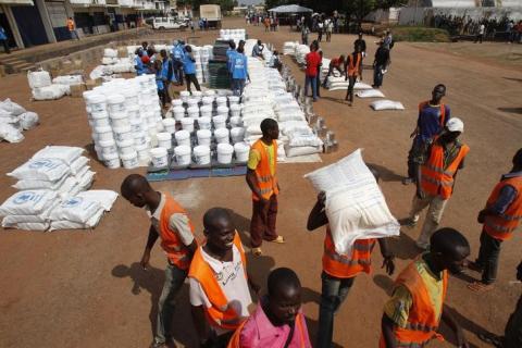 Aid workers unload food to be distributed at a camp for people displaced by the recent unrest, at the Mpoko international airport of Bangui, February 12, 2014. PHOTO BY REUTERS/Luc Gnago
