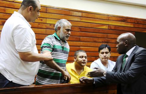 Baktash Akasha, Gulam Hussein, Ibrahim Akasha and Vijaygiri Goswami are briefed by their lawyer Cliff Ombeta at Mombasa Law Courts. PHOTO BY REUTERS/Joseph Okanga