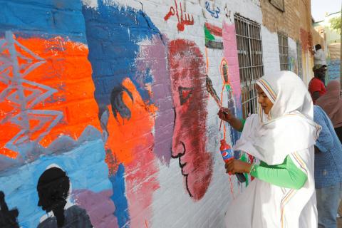 Amna Almahi works on a mural near the defence ministry compound in Khartoum, Sudan, April 22, 2019. PHOTO BY REUTERS/Umit Bektas