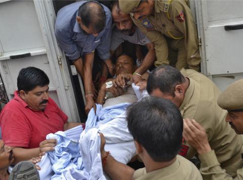 An injured policeman is rushed to a hospital for treatment, in Jammu