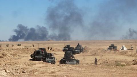 Iraqi security forces vehicles move toward the town of Hit during a military operation, in west of Ramadi, March 8, 2016. PHOTO BY REUTERS/Stringer