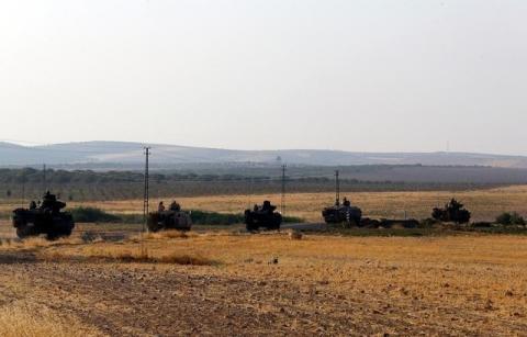 Turkish armoured personnel carriers drive towards the border in Karkamis on the Turkish-Syrian border in the southeastern Gaziantep province, Turkey, August 27, 2016. PHOTO BY REUTERS/Umit Bektas