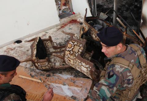 Lebanese army soldiers inspect the damage as bloodstains are seen on the floor following a raid on an apartment, in the northern town of Asoun, October 23, 2014. PHOTO BY REUTERS/Omar Ibrahim