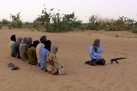 The leader of the Coordination of Azawad Movements (CMA), Mohamed Ag Najim (R), leads his men in prayer outside Anefis, Mali, August 26, 2015. PHOTO BY REUTERS/Souleymane Ag Anara