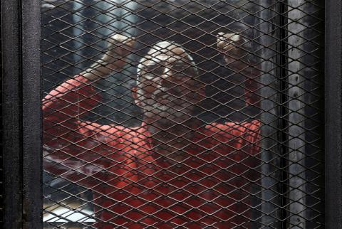 Muslim Brotherhood's leader Mohamed Badie shouts slogans against the Interior Ministry behind bars during the trial of 738 brotherhood members for their armed sit-in at Rabaa square, at a court on the outskirts of Cairo, Egypt, May 31, 2016. PHOTO BY REUTERS