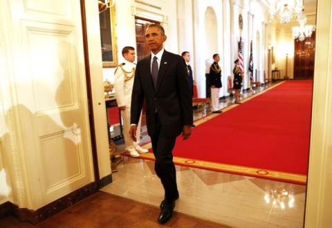 U.S. President Barack Obama walks in before he awards two Medals of Honor for actions during the Vietnam War while in the East Room of the White House in Washington