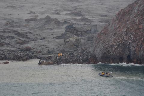 Members of a rescue crew are seen at the White Island volcano, also known by its Maori name Whakaari, in New Zealand, December 13, 2019, in this image obtained via social media. PHOTO BY REUTERS/New Zealand Defence Force/Handout 