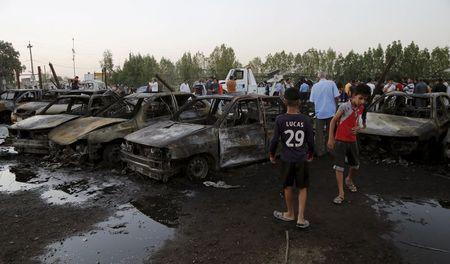 Residents gather at the site of a car bomb attack at the mainly Shi'ite district of Habibiya in Baghdad, August 15, 2015. PHOTO BY REUTERS/Wissm Al- Okili