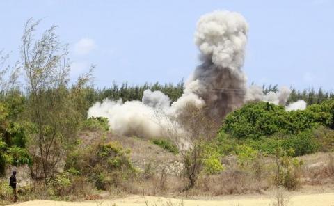 A bomb expert walks away as a cloud of smoke bellows in the air when explosives seized from two suspected Somali Islamist militants were detonated, in the Mtwapa area near Kenya's coastal city of Mombasa, March 20, 2014. PHOTO BY REUTERS/Joseph Okanga