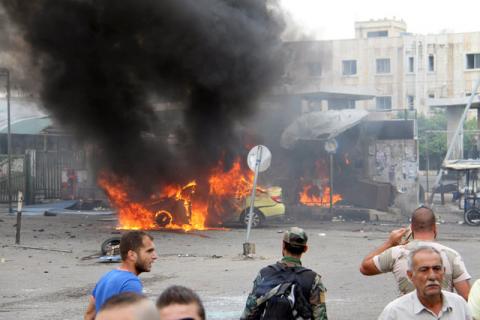 A Syrian army soldier and civilians inspect the damage after explosions hit the Syrian city of Tartous, in this handout picture provided by SANA, May 23, 2016. PHOTO BY REUTERS/SANA