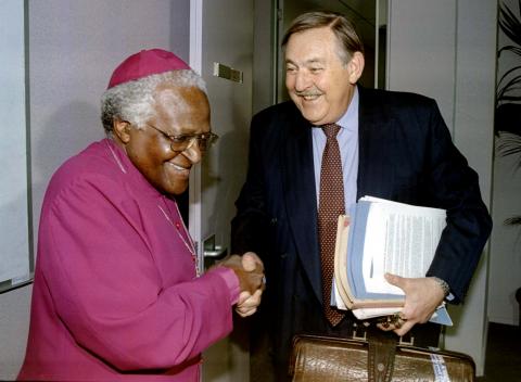 Former South African Foreign Minister Pik Botha shakes hands with Archbishop Desmond Tutu at the Truth and Reconciliation Commission (TRC) in Johannesburg, South Africa, October 14,1997. PHOTO BY REUTERS/Juda Ngwenya
