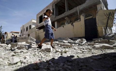 A boy walks past the a house damaged by a Saudi-led air strike in Yemen's capital Sanaa, September 12, 2015. PHOTO BY REUTERS/Mohamed al-Sayaghi