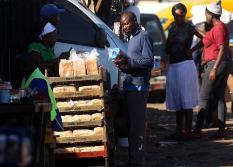 A man buys bread from a street vendor in Mbare township, Harare, Zimbabwe, January 24, 2019. PHOTO BY REUTERS/Philimon Bulawayo