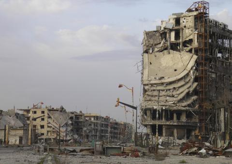 Damaged buildings are pictured in the besieged area of Homs