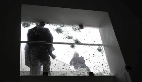 A photographer takes pictures of bulletholes after last week's attack on the national Bardo museum, in Tunis, March 27, 2015. PHOTO BY REUTERS/Zoubeir Souissi