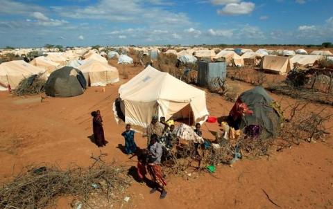 Refugees stand outside their tent at the Ifo Extension refugee camp in Dadaab, near the Kenya-Somalia border in Garissa County, Kenya, October 19, 2011. PHOTO BY REUTERS/Thomas Mukoya