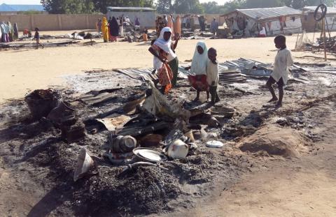 People stand amid the damage at a camp for displaced people after an attack by suspected Boko Haram insurgents in Dalori, Nigeria, November 1, 2018. REUTERS/Kolawole Adewale