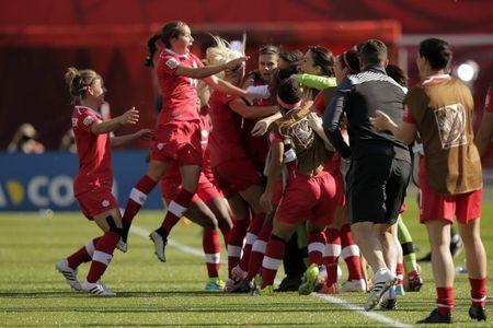 Canada forward Christine Sinclair (12) celebrates with teammates after scoring a goal on a penalty kick against China during the second half in a Group A soccer match in the 2015 women's World Cup at Commonwealth Stadium, Edmonton, Alberta, CAN, Jun 6, 2015. PHOTO BY USA TODAY Sports/Erich Schlegel