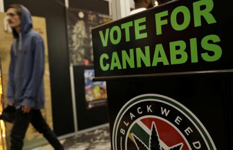 A guest walks past a poster during the opening of the four-day Cannabis expo in Pretoria, South Africa, December 13, 2018. PHOTO BY REUTERS Siphiwe Sibeko