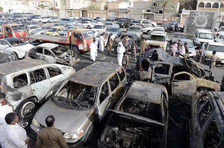 Policemen inspect a site where a car exploded near a Shi'ite mosque in Saudi Arabia's Dammam, May 29, 2015. PHOTO BY REUTERS/Faisal Alnasser