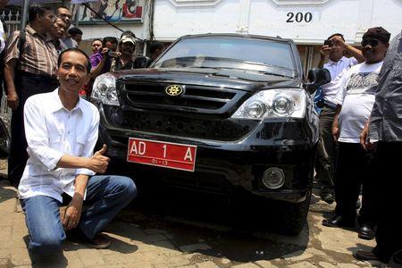 Then-mayor of Solo Joko Widodo poses with a locally made Esemka car, February 25, 2012. PHOTO BY REUTERS/Dhoni Setiawan