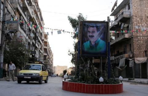 A car passes by a picture of the Kurdish leader Abdullah Ocalan of the Kurdistan Workers Party (PKK) in Aleppo's Sheikh Maqsoud neighbourhood, Syria, July 15, 2017. PHOTO BY REUTERS/Omar Sanadiki