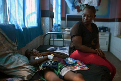 Khadija Kamara sits next to her son Carlos, who she says hasn't been seen by staff at Freetown's Connaught Hospital in days, despite needing surgery to remove a foreign object lodged in his windpipe, in Freetown, Sierra Leone, December 12, 2018. PHOTO BY REUTERS/Cooper Inveen