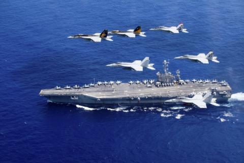 A combined formation of aircraft from Carrier Air Wing (CVW) 5 and Carrier Air Wing (CVW) 9 pass in formation above the Nimitz-class aircraft carrier USS John C. Stennis (CVN 74) in the Philippine Sea on June 18, 2016. Courtesy Steve Smith/U.S. Navy/Handout via REUTERS