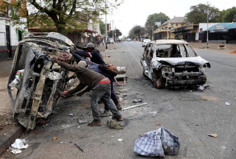 Scrap metal collectors prepare to transport a shell of a car after it was burnt during xenophobic attacks that took place earlier this week in Johannesburg, South Africa, September 5, 2019. PHOTO BY REUTERS/Siphiwe Sibeko