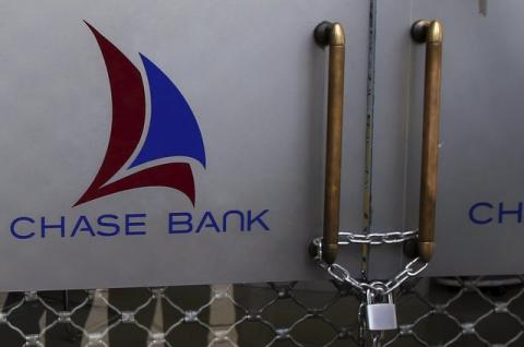 The logo of Chase Bank is seen on the closed entrance of one of its branches, after the bank was put under receivership, in Nairobi, Kenya, April 8, 2016. PHOTO BY REUTERS/Siegfried Modola