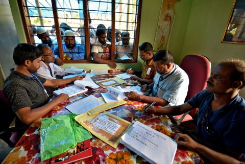 People wait to check their names on the draft list at the National Register of Citizens (NRC) centre at a village in Nagaon district, Assam state, India, July 30, 2018. PHOTO BY REUTERS/Stringer