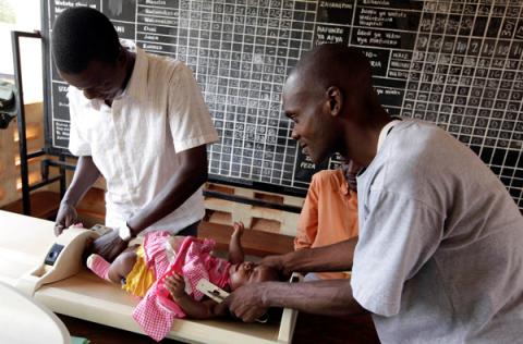 Kenyan nurses weigh a child before she is given an injection as part of a malaria vaccine trial at a clinic in the Kenya coastal town of Kilifi, November 23, 2010. PHOTO BY REUTERS/Joseph Okanga