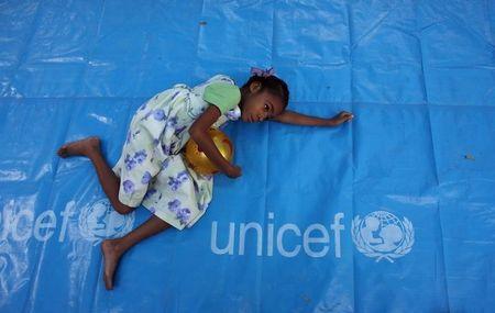 A child rests as Ann M. Veneman, UNICEF Executive Director, visits the Notre Dame orphanage in Port-au-Prince, February 4, 2010. PHOTO BY REUTERS/Eduardo Munoz